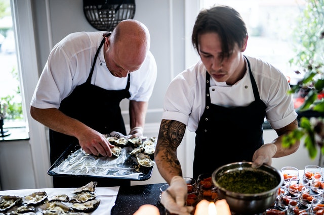 Two chefs preparing food for Melbourne catering